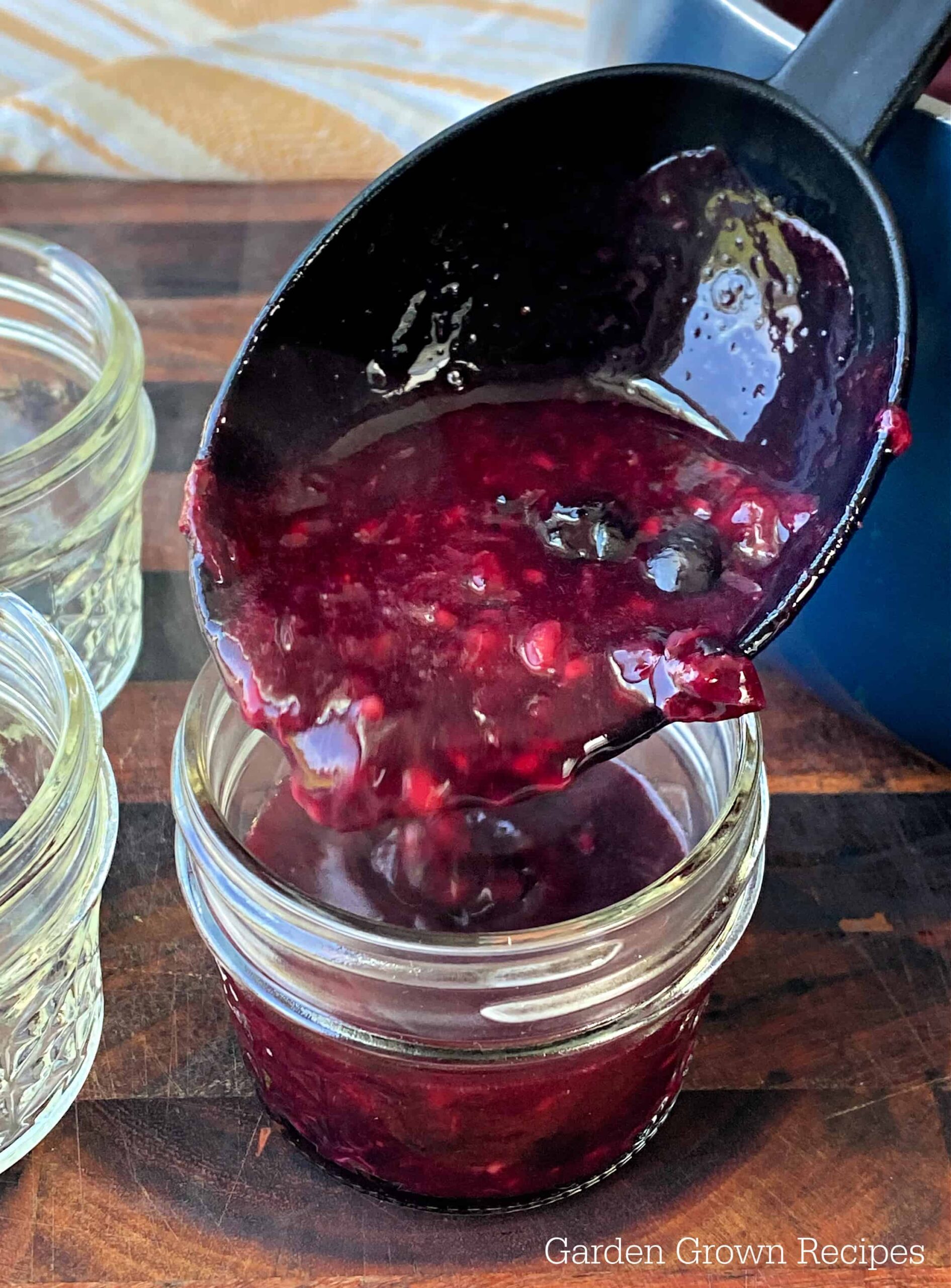 ladle jam into jelly jars, mixed berry jelly