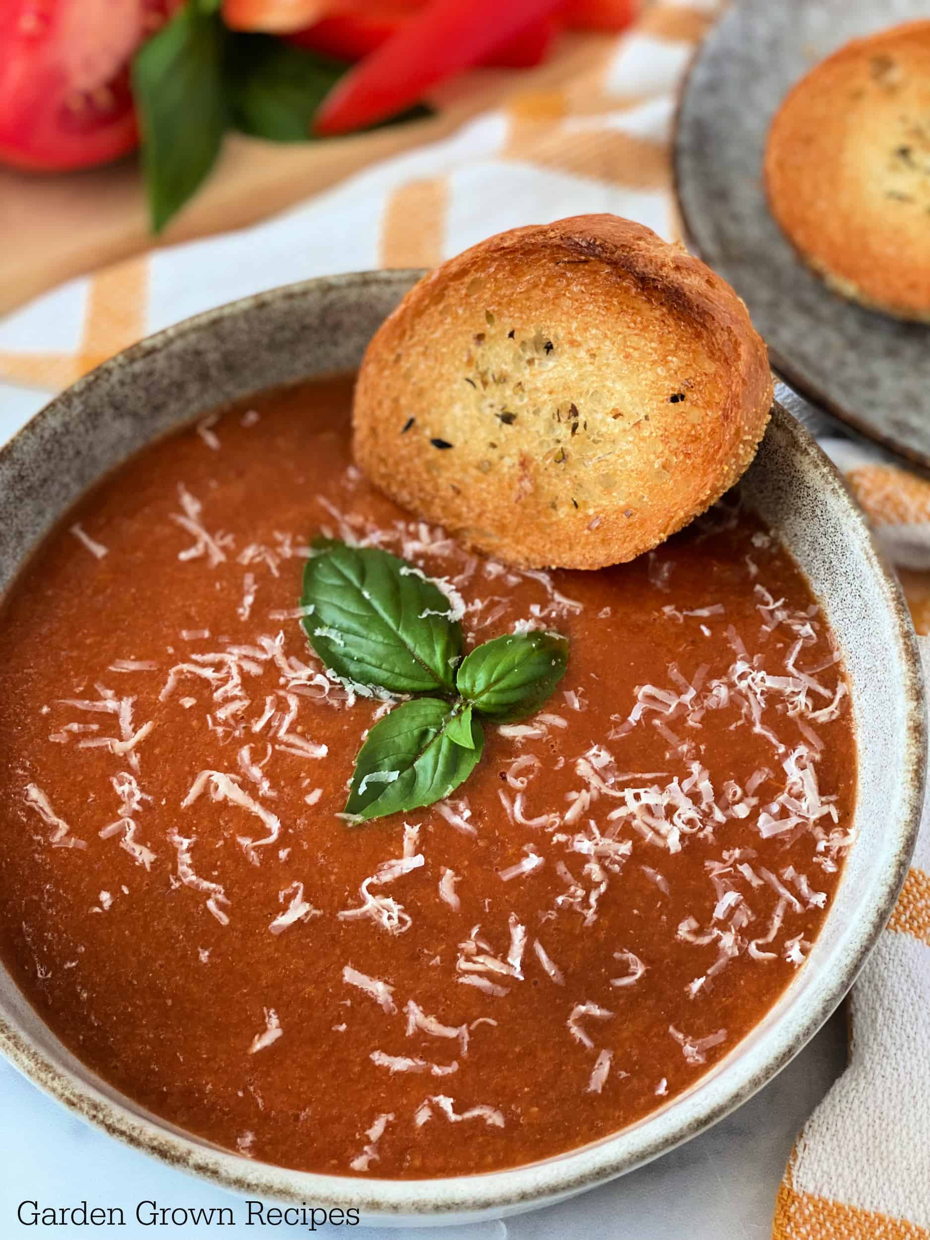 crusty bread in Roasted Red Pepper Tomato Soup bowl