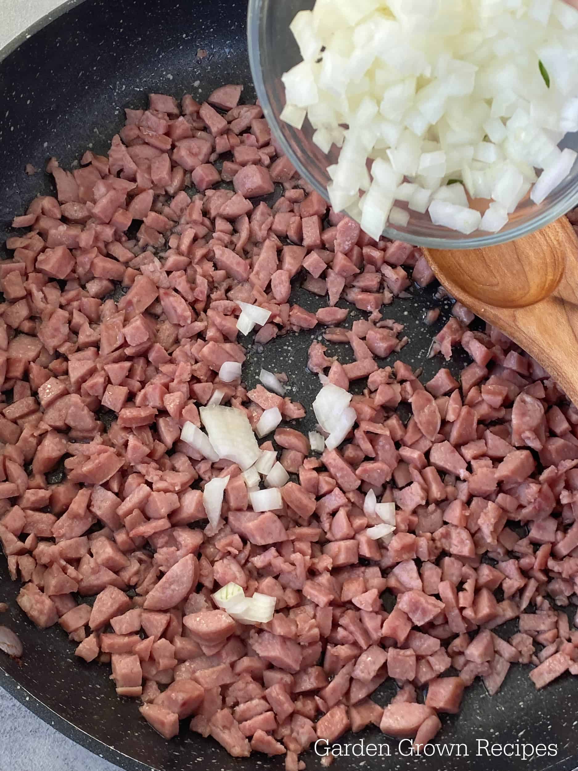 onions in skillet with breakfast sausage 